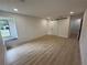 Bedroom with wood-look flooring, natural light and a barn door leading to an en suite at 23220 Shining Star Dr, Land O Lakes, FL 34639