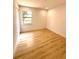 Comfortable bedroom featuring a window for natural light and wood-look flooring at 23220 Shining Star Dr, Land O Lakes, FL 34639