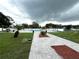 Community pool with lounge chairs and umbrellas for relaxing on sunny days at 23220 Shining Star Dr, Land O Lakes, FL 34639