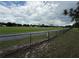 Large, grassy field bordered by a fence, perfect for recreational activities at 23220 Shining Star Dr, Land O Lakes, FL 34639