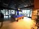 Spacious game room featuring two billiards tables, high top tables, and large windows for lots of natural light at 23220 Shining Star Dr, Land O Lakes, FL 34639