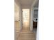 Bright hallway showcases wood-look flooring and leads to the bedrooms and bathroom at 23220 Shining Star Dr, Land O Lakes, FL 34639