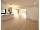 Bright open-concept living room with light wood floors and recessed lighting throughout the space at 23220 Shining Star Dr, Land O Lakes, FL 34639