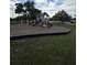 A modern playground featuring slides and climbing structures, set against a lush green lawn at 23220 Shining Star Dr, Land O Lakes, FL 34639