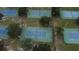 Aerial view of the community tennis courts in a lush green neighborhood at 23220 Shining Star Dr, Land O Lakes, FL 34639