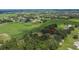 Expansive aerial view of the property featuring green fields and surrounding neighborhoods with arrow pointing at the property at 3102 E Trapnell Rd, Plant City, FL 33566