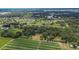 Aerial view of property featuring a tree filled yard, farmland, and residential area nearby at 3102 E Trapnell Rd, Plant City, FL 33566