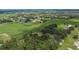 Expansive aerial view of the property featuring green fields and surrounding neighborhoods with a view of nearby baseball field at 3102 E Trapnell Rd, Plant City, FL 33566