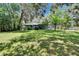 Large backyard featuring mature trees, a screened porch and lots of shade at 3102 E Trapnell Rd, Plant City, FL 33566