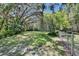 Spacious backyard with lush green grass and mature trees, fully fenced at 3102 E Trapnell Rd, Plant City, FL 33566