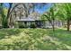 Spacious backyard featuring mature trees, a screened porch and lots of shade at 3102 E Trapnell Rd, Plant City, FL 33566