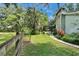 View of side of home and lush backyard with screened pool area at 3102 E Trapnell Rd, Plant City, FL 33566