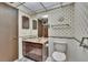 Traditional bathroom with wallpaper, dark wood cabinets, and tiled floor at 3102 E Trapnell Rd, Plant City, FL 33566