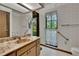 Bathroom features patterned wallpaper, marble countertop vanity, and a window for natural light at 3102 E Trapnell Rd, Plant City, FL 33566