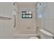 The bathroom features a bathtub, toilet, and a window above the tub offering natural light at 3102 E Trapnell Rd, Plant City, FL 33566