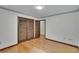 Spacious bedroom featuring hardwood floors, a closet with sliding doors and an additional door at 3102 E Trapnell Rd, Plant City, FL 33566