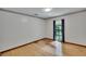 Bedroom with hardwood flooring, white walls, a window with curtains, and decorative trim at 3102 E Trapnell Rd, Plant City, FL 33566