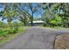 Long driveway leading to house surrounded by beautiful landscape at 3102 E Trapnell Rd, Plant City, FL 33566