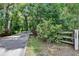 Long paved driveway leading to property through a canopy of trees and lush landscaping at 3102 E Trapnell Rd, Plant City, FL 33566