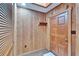 Warm wood-paneled entryway featuring a coat rack and traditional wooden door at 3102 E Trapnell Rd, Plant City, FL 33566
