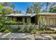 Unique home with architectural details, mature landscaping, and a metal roof at 3102 E Trapnell Rd, Plant City, FL 33566