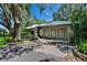 Attractive home with metal roof, attached garage, and mature landscaping at 3102 E Trapnell Rd, Plant City, FL 33566