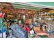 View of a cluttered storage area or garage filled with lawn equipment, wood scraps, and various household items at 3102 E Trapnell Rd, Plant City, FL 33566