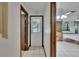 Hallway with tile flooring and a white door leading to the outside with views into an adjacent dining room at 3102 E Trapnell Rd, Plant City, FL 33566