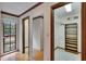 Hallway featuring wood floors, a closet with shelves, and a mirror in the hall at 3102 E Trapnell Rd, Plant City, FL 33566
