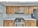 Full kitchen view featuring wood cabinets, white marble countertops, and stainless steel appliances at 3102 E Trapnell Rd, Plant City, FL 33566