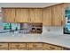 The kitchen has wood cabinets and white marble countertops, with a view of the living room at 3102 E Trapnell Rd, Plant City, FL 33566