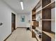 Functional laundry room with built-in shelving, utility sink, and a patterned linoleum floor at 3102 E Trapnell Rd, Plant City, FL 33566