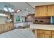 Open floor plan living room featuring wood and tile floors, brick fireplace, and lots of light at 3102 E Trapnell Rd, Plant City, FL 33566