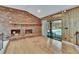 Cozy living room featuring a fireplace, hardwood floors, and access to the pool at 3102 E Trapnell Rd, Plant City, FL 33566