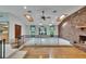 Bright living room with a brick fireplace, skylights, and hardwood flooring at 3102 E Trapnell Rd, Plant City, FL 33566