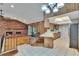 Open floor plan living room featuring wood and tile floors, brick fireplace, and lots of light at 3102 E Trapnell Rd, Plant City, FL 33566