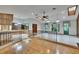 Open-concept living room featuring hardwood floors, a ceiling fan, and natural light at 3102 E Trapnell Rd, Plant City, FL 33566