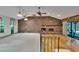 Spacious living room with carpet and wood floors, a brick fireplace, and vaulted ceilings at 3102 E Trapnell Rd, Plant City, FL 33566