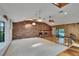 Spacious living room with fireplace, skylights, and view of the pool area at 3102 E Trapnell Rd, Plant City, FL 33566