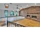 Spacious living room with carpet and wood floors, a brick fireplace, and vaulted ceilings at 3102 E Trapnell Rd, Plant City, FL 33566