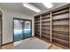Office room with hardwood flooring, built-in bookshelves, and a sliding glass door to the outside at 3102 E Trapnell Rd, Plant City, FL 33566