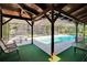 View of the in-ground screened pool with built-in seating and a spacious deck at 3102 E Trapnell Rd, Plant City, FL 33566