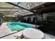 Inviting screened-in pool with a picnic table and ample space for entertaining, showcasing a backyard at 3102 E Trapnell Rd, Plant City, FL 33566
