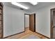 Room featuring hardwood floors, a sliding door, an open doorway, and built-in shelves at 3102 E Trapnell Rd, Plant City, FL 33566