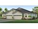Charming single-story home featuring a two-car garage, dark roof, stone accents, and well-maintained landscaping at 31442 Paper Birch St, Wesley Chapel, FL 33545