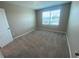 Bedroom features carpet flooring, a neutral wall color, and a window with a view at 35233 White Water Lily Way, Zephyrhills, FL 33541
