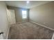 This bedroom has neutral paint and carpet, a window for natural light, and a closet for storage at 35233 White Water Lily Way, Zephyrhills, FL 33541