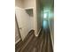 Hallway with wood floors and a walk-in closet featuring ample storage space with white trim and an open door at 35233 White Water Lily Way, Zephyrhills, FL 33541