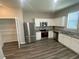 This kitchen features stainless steel appliances, granite countertops, and white cabinets at 35233 White Water Lily Way, Zephyrhills, FL 33541