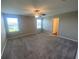 This spacious main bedroom has multiple windows for natural light and a ceiling fan for comfort at 35233 White Water Lily Way, Zephyrhills, FL 33541